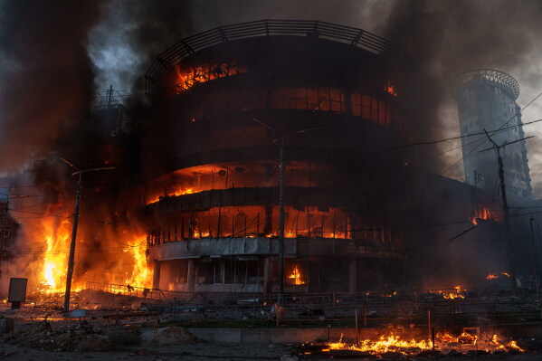 A trade center burns after a Russian strike on Kyiv, Ukraine, on Sunday, May 24, 2026. (AP Photo/Evgeniy Maloletka)