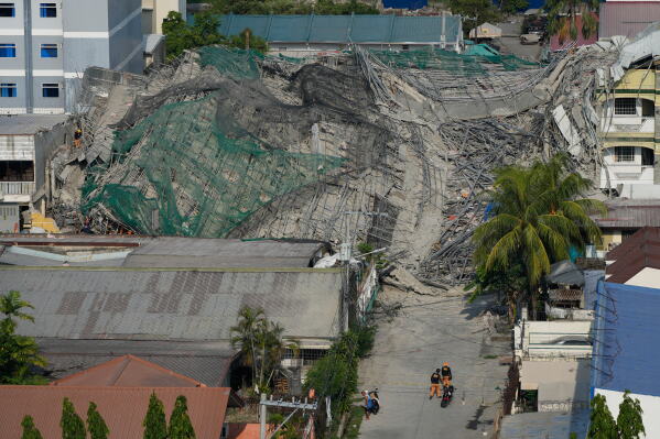Rescuers continue search operations at a collapsed building where multiple people are believed to be trapped in Angeles city in Pampanga province, north of Manila, Philippines, Monday, May 25, 2026. (AP Photo/Aaron Favila)
