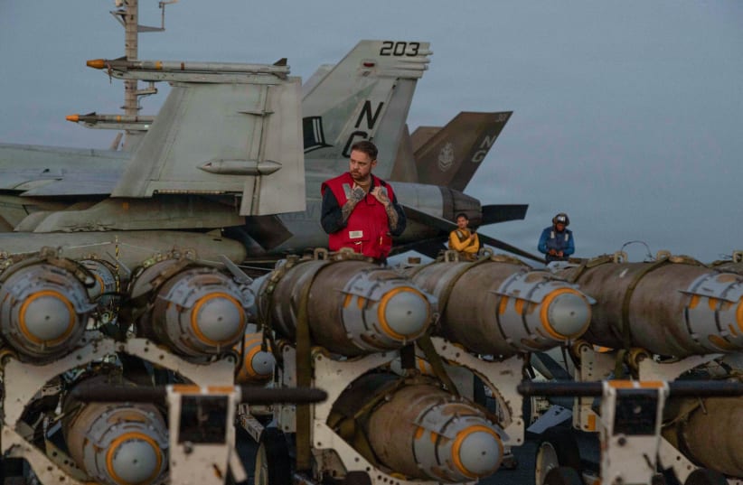 US Navy sailors transfer ordnance on the flight deck of the Nimitz-class aircraft carrier USS Abraham Lincoln in the Arabian Sea, February 27, 2026.