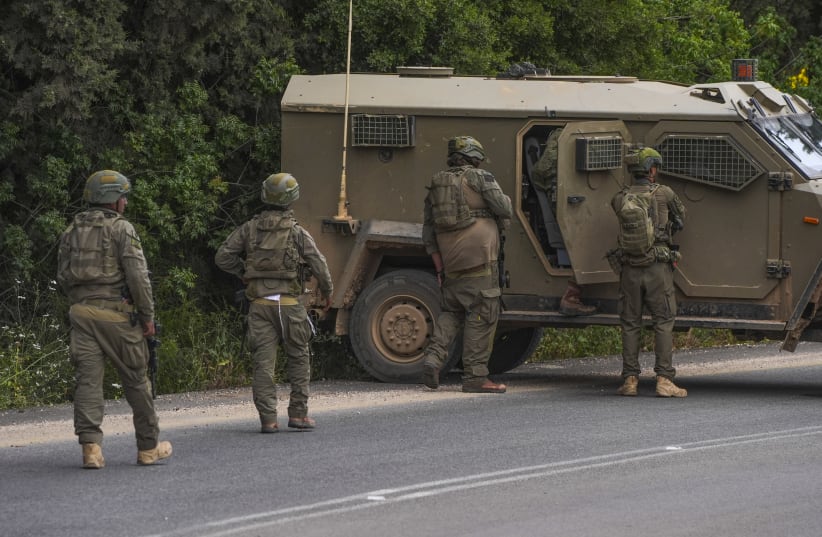 Israeli soldiers take position during a Hezbollah attack near the Israeli border with Lebanon in northern Israel, May 19, 2026.