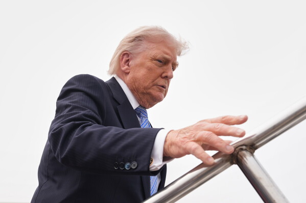 President Donald Trump boards Air Force One, Friday, May 15, 2026, at Beijing Capital International Airport in Beijing. (AP Photo/Mark Schiefelbein)