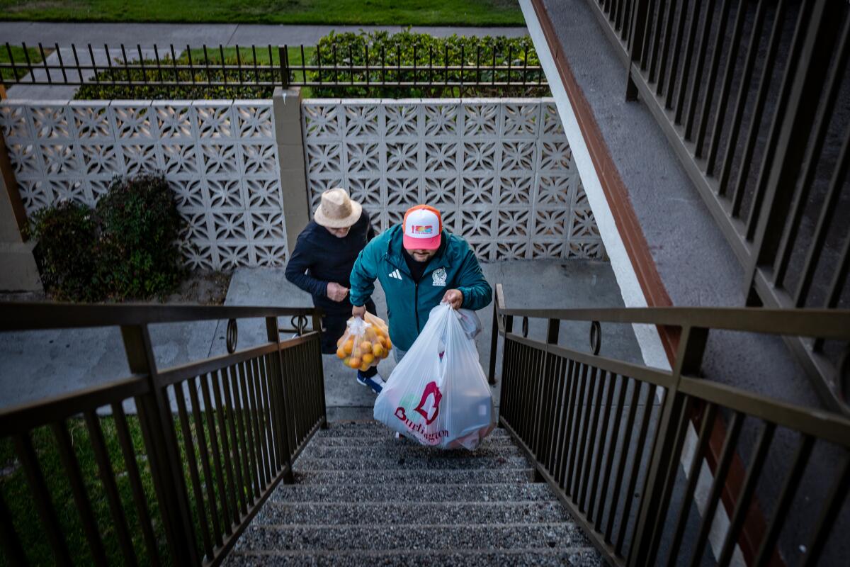 Two people walking up stairs