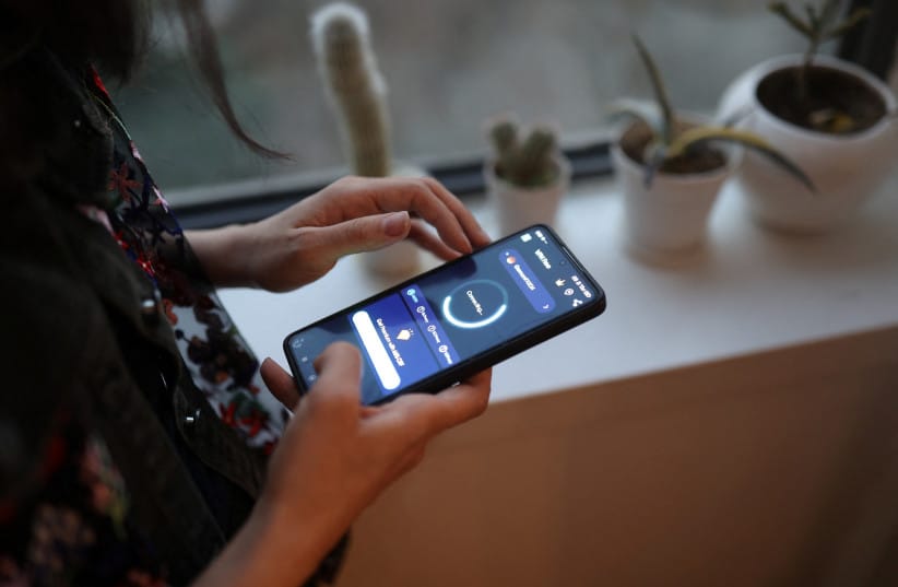 An Iranian woman, Boshra, shows her mobile phone, after a nationwide internet shutdown since January 8, 2026, following Iran's protests, in Tehran, Iran, January 24, 2026. (credit: MAJID ASGARIPOUR/WANA