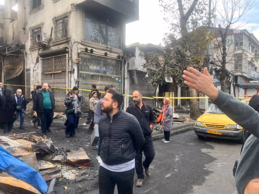 People walking at Rasht bazaar the day after the fire in January  
