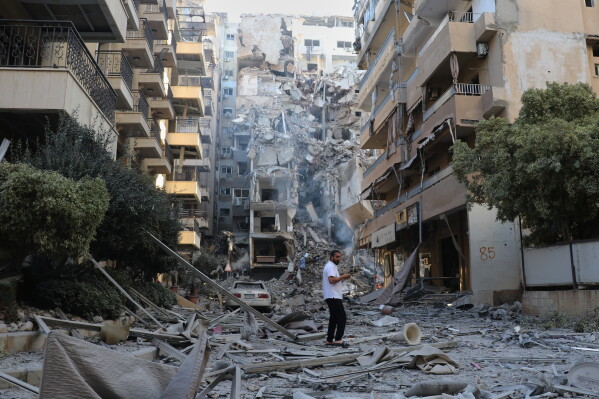 A man checks the site of destroyed buildings that were hit in Israeli airstrikes in the southern port city of Tyre, Lebanon, Thursday, May 28, 2026. (AP Photo)