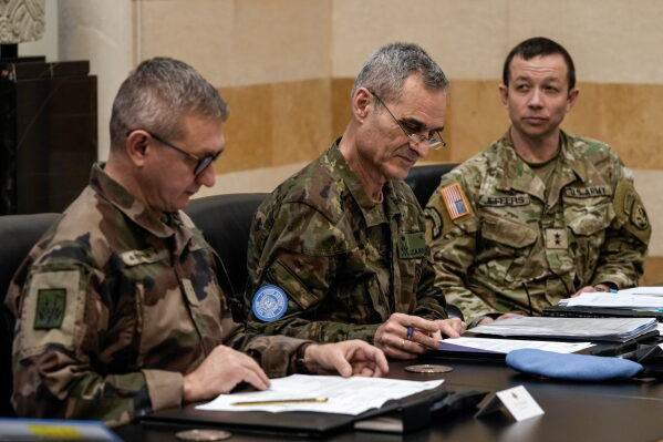 Members of the committee monitoring the Lebanon-Israel ceasefire, the Head of Mission and Force Commander of the United Nations Interim Force in Lebanon (UNIFIL), Major General Aroldo Lazaro Saenz, of Spain, center, US Maj. Gen. Jasper Jeffers, right, and Gen. Guillaume Ponchamp, of France, left, meet with Lebanese caretaker Prime Minister Najib Mikati, at the government palace in Beirut, Dec. 24, 2024. (AP Photo/Bilal Hussein, File)