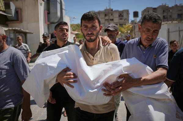 Nabil Abu Labda carries the body of his 6-year-old daughter, Menna Allah Abu Labda, who was killed in an Israeli airstrike, during her funeral at Nasser Hospital in Khan Younis, Gaza Strip, Monday, May 25, 2026. (AP Photo/Abdel Kareem Hana)