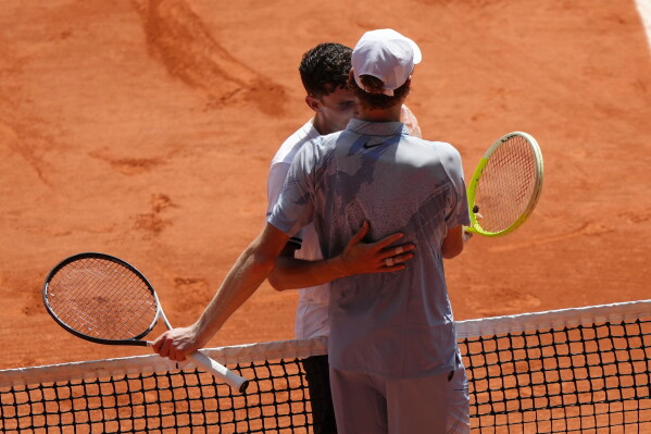 Jannik Sinner of Italy, right, and Juan Manuel Cerundolo of Argentina hug after their second round men's singles tennis match at the French Open tennis tournament in Paris, Thursday, May 28, 2026. (AP Photo/Aurelien Morissard)