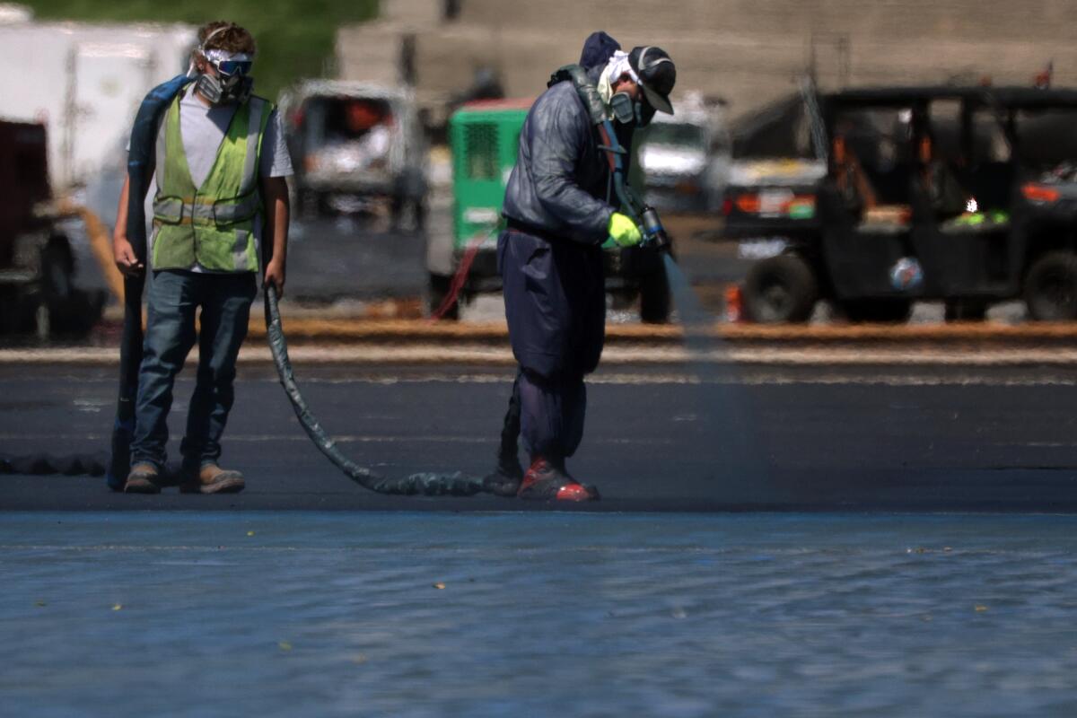 Workers paint the bottom of the Lincoln Memorial Reflecting Pool.