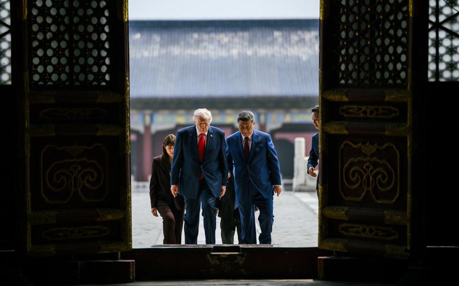President Donald Trump and Chinese President Xi Jinping wear suits as they walk into a temple together.