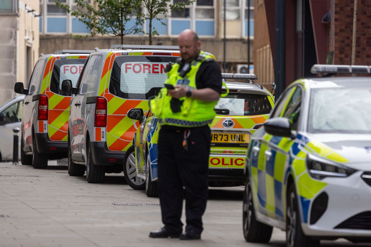 Police and forensics on scene at a building on Redcliff Street.