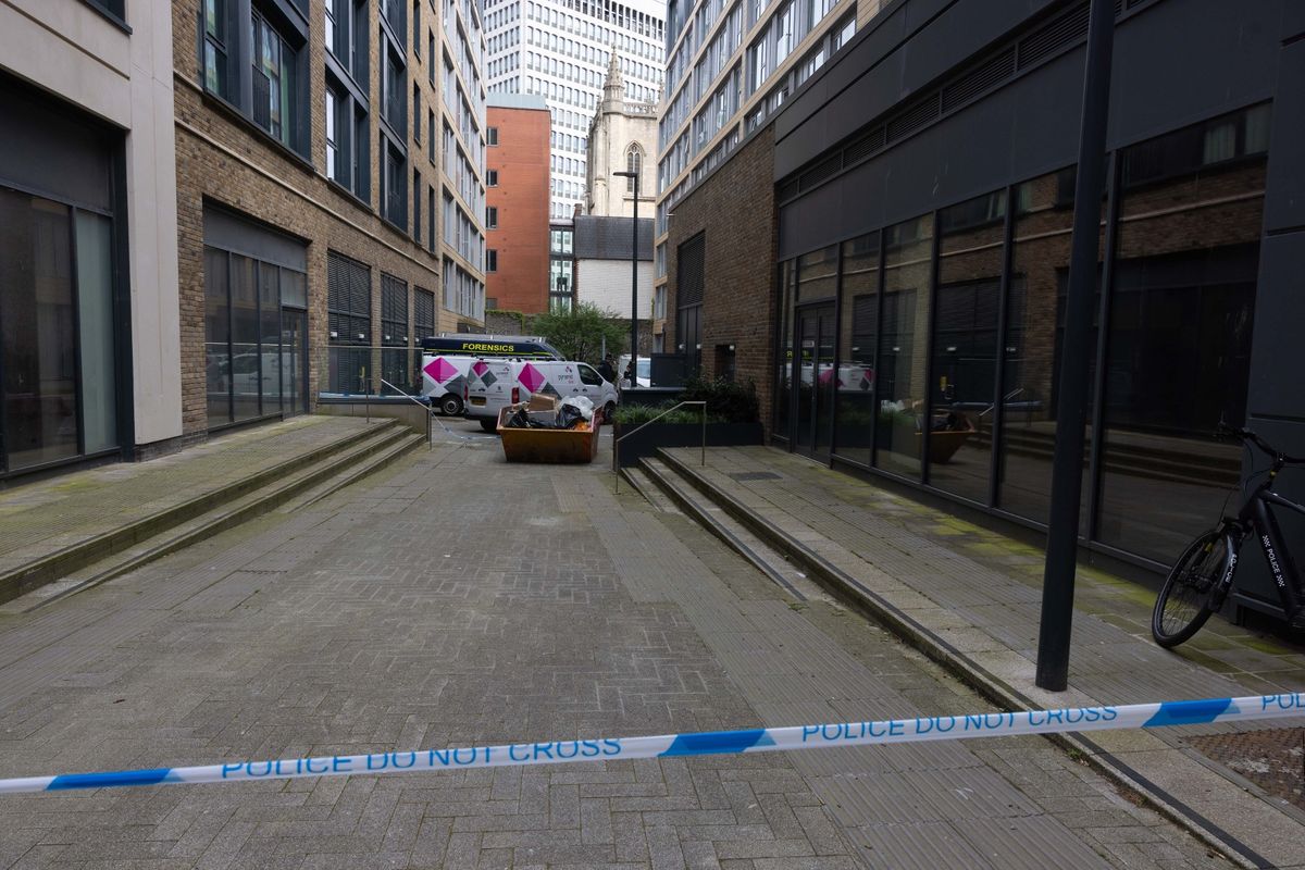 Police and forensics on scene at a building on Redcliff Street.