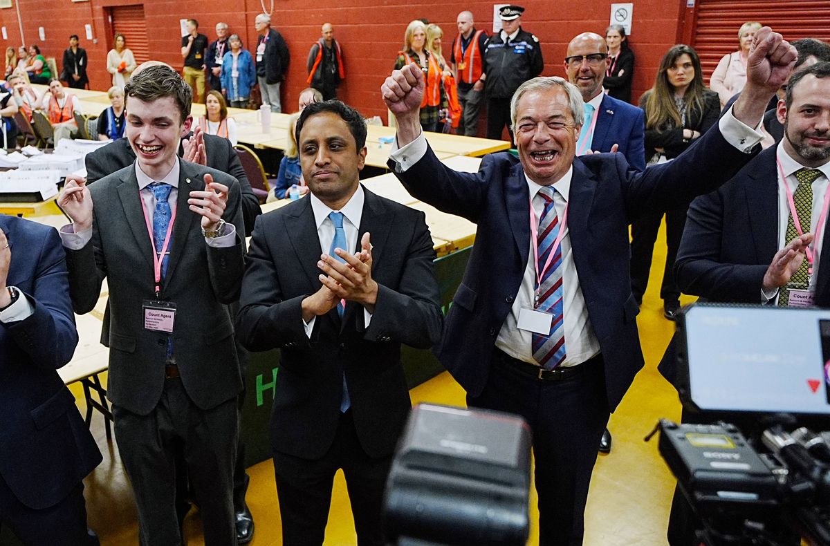 Reform UK leader Nigel Farage (right) and chair Zia Yusuf (centre) celebrate for the media after Reform candidate Sarah Pochin won the Runcorn and Helsby by-election at DCBL Halton Stadium, Widnes, Cheshire. Picture date: Friday May 2, 2025.
