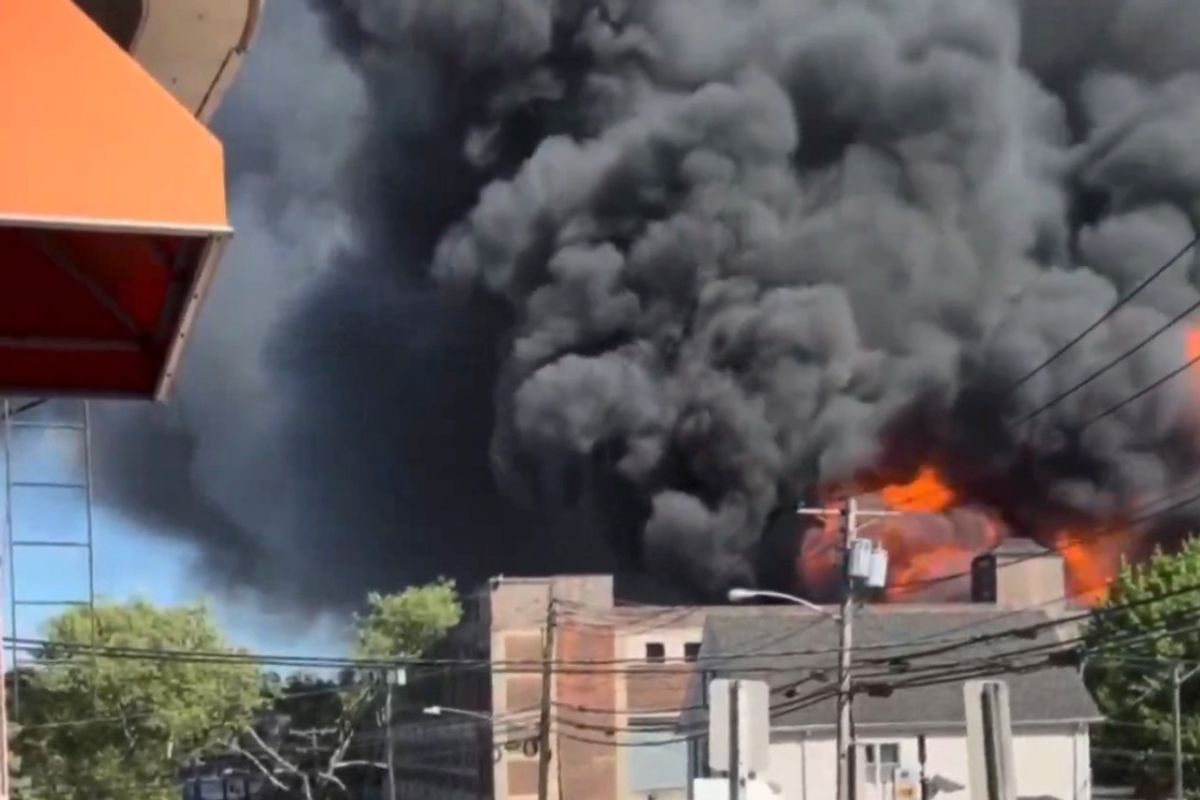 A nine-alarm fire in northern New Jersey engulfed a commercial building Saturday night, with embers spreading flames to nearby structures as firefighters battled the blaze
