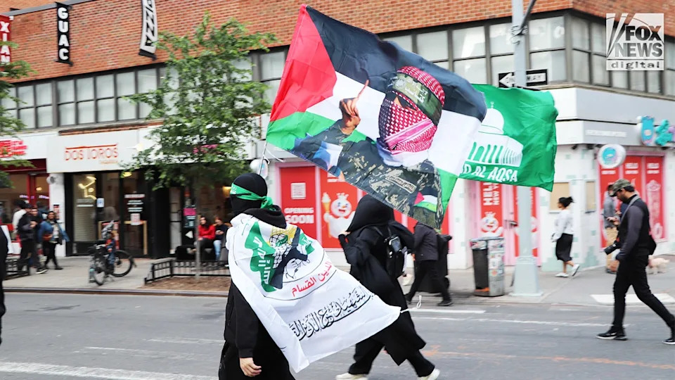 Demonstrators holding an Al-Qassam Brigades flag during a protest in Manhattan