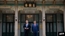 US President Donald Trump poses for photos with China’s Xi Jinping during a visit to Zhongnanhai Garden in Beijing on May 15.
