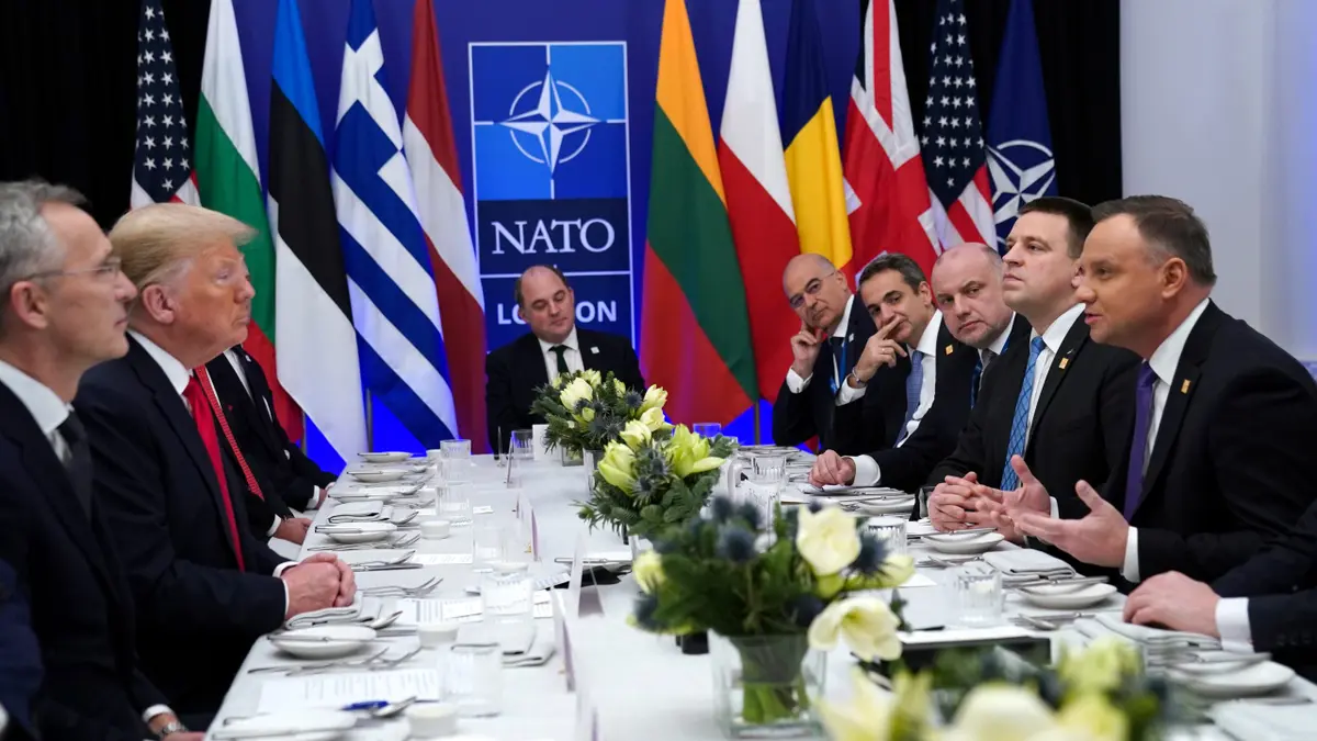 NATO Secretary General Jens Stoltenberg looking on as U.S. President Donald Trump and Poland's President Andrzej Duda talk during a working lunch