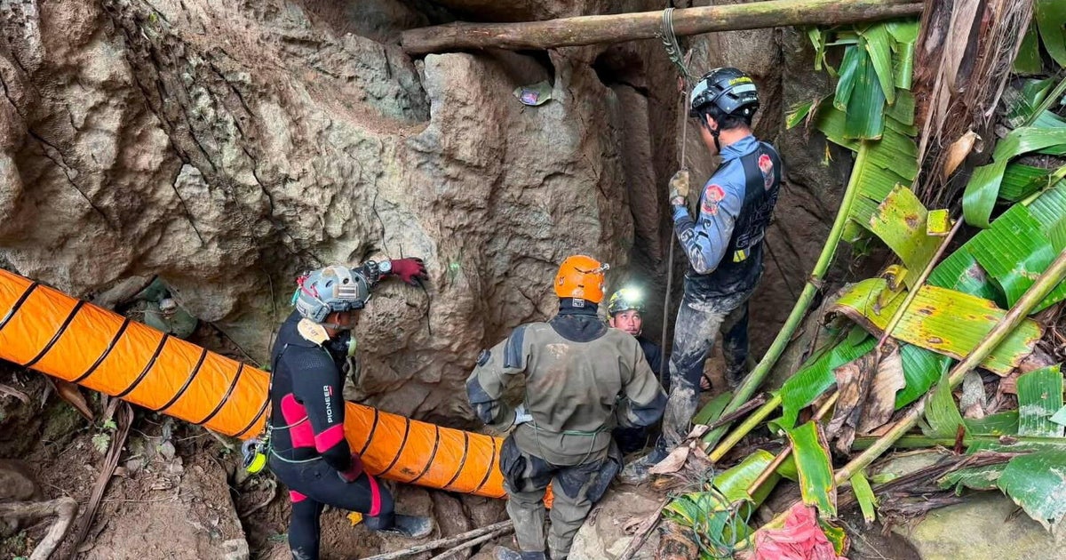Members of a rescue team work to save seven people trapped in a cave, at a location given as Xaisomboun Province