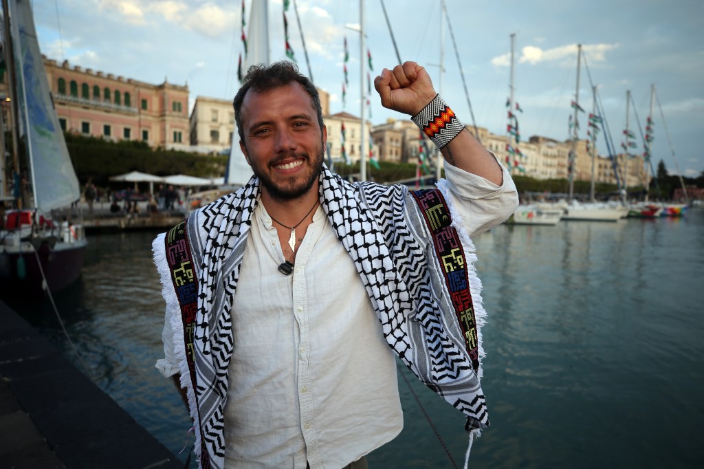 Brazilian activist Thiago Avila speaks at Port of Siracusa in Sicily, Italy, showing determination to break the Gaza blockade.