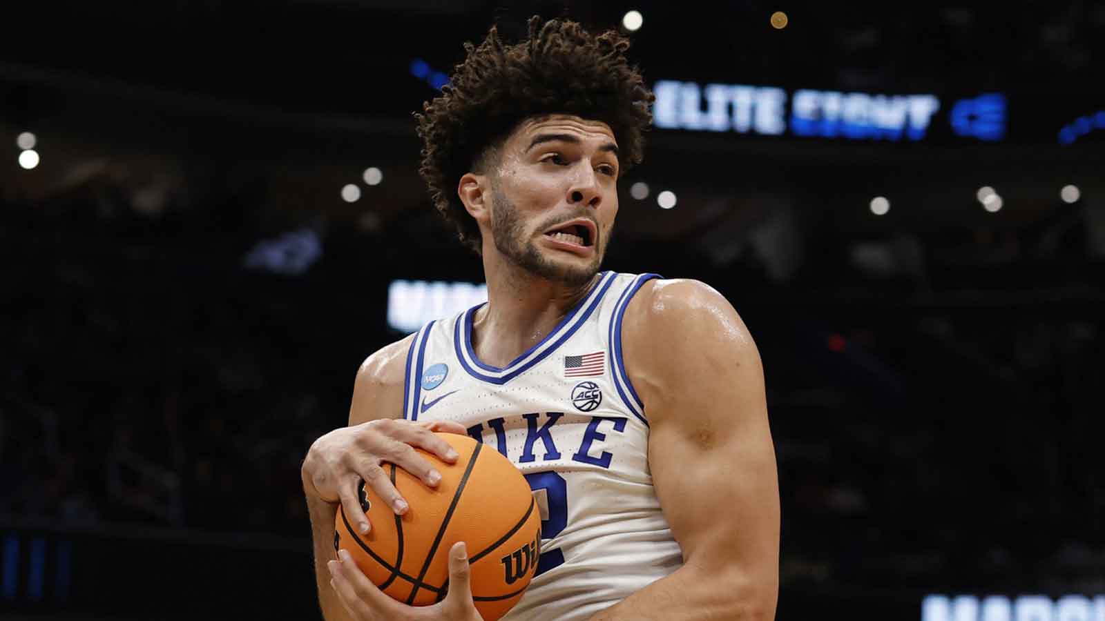 Duke Blue Devils forward Cameron Boozer (12) rebounds the ball against the UConn Huskies in the first half during an Elite Eight game of the East Regional of the men's 2026 NCAA Tournament at Capital One Arena.