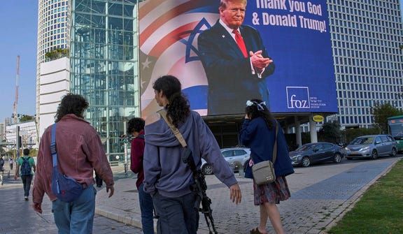 An electronic billboard displaying an image of President Donald Trump alongside the message "Thank you God and Donald Trump," in Tel Aviv, Israel, during the war against Iran.