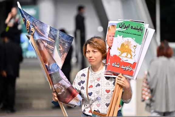 A protester holds demonstration placards outside the Vancouver Convention Centre during the 76th FIFA Congress on April 30, 2026.