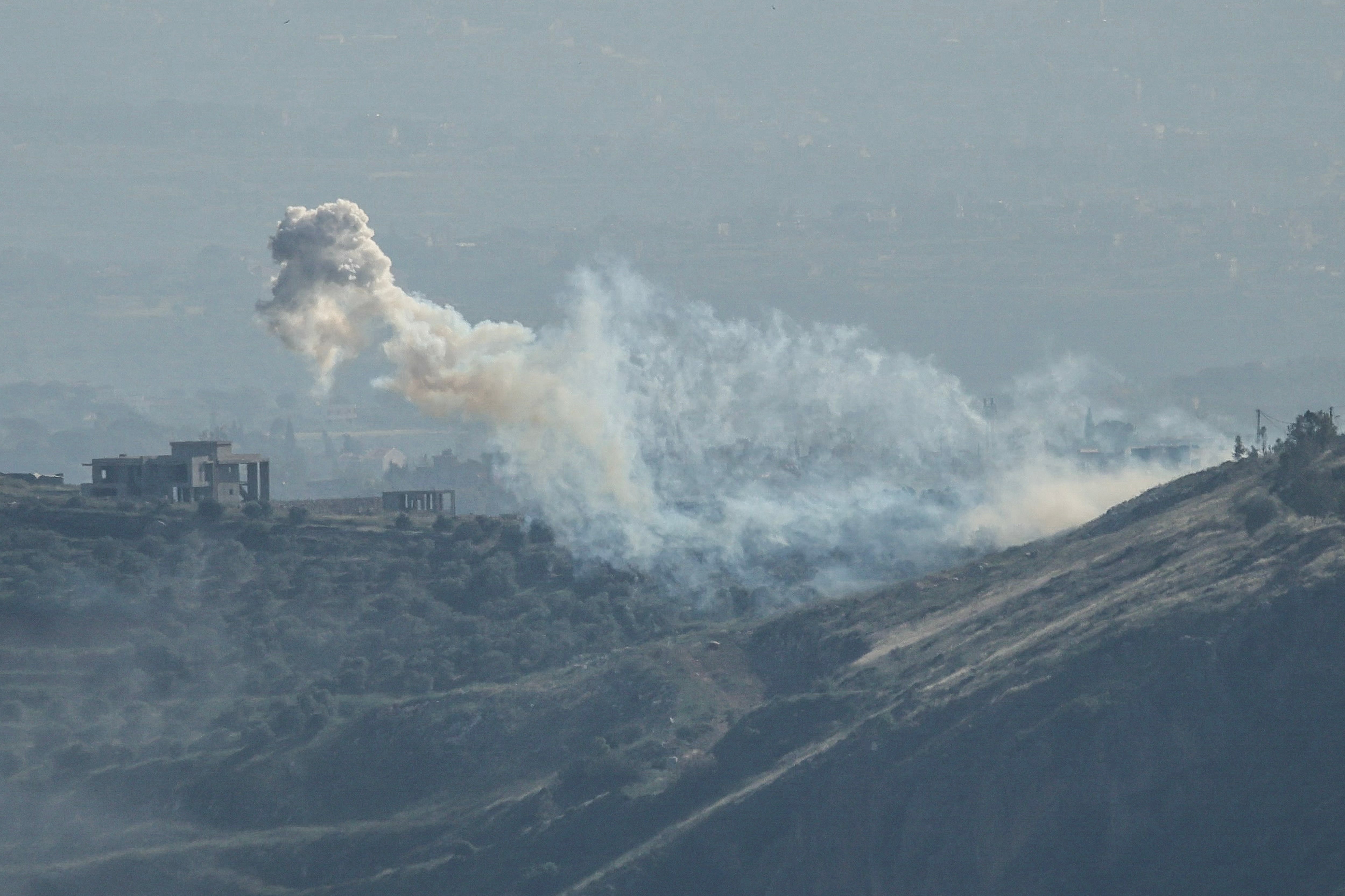 Smoke rising during Israeli shelling targeting the outskirts of the village of Yohmor on May 10, 2026