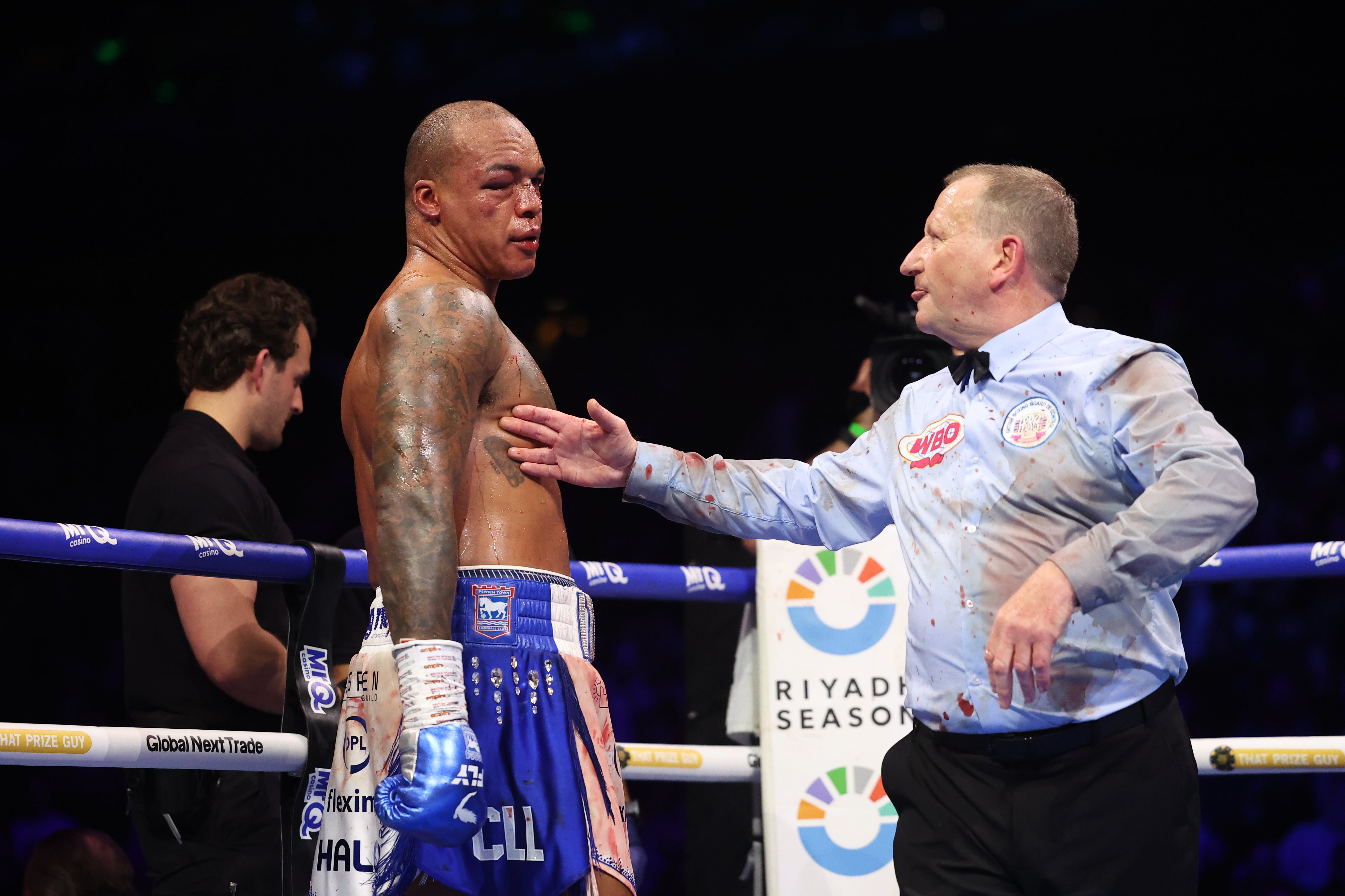 A ringside doctor (left) and referee Howard Foster checked on Wardley before rounds nine and 10