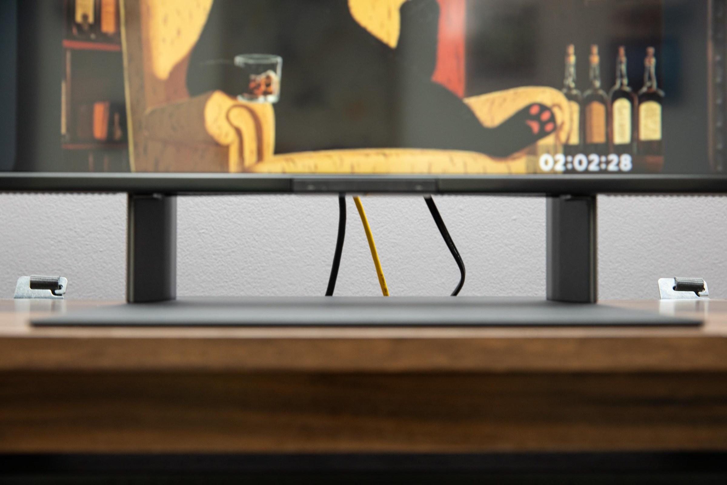 I closeup of the Sony Bravia 7 II stand without its cover showing cables behind.