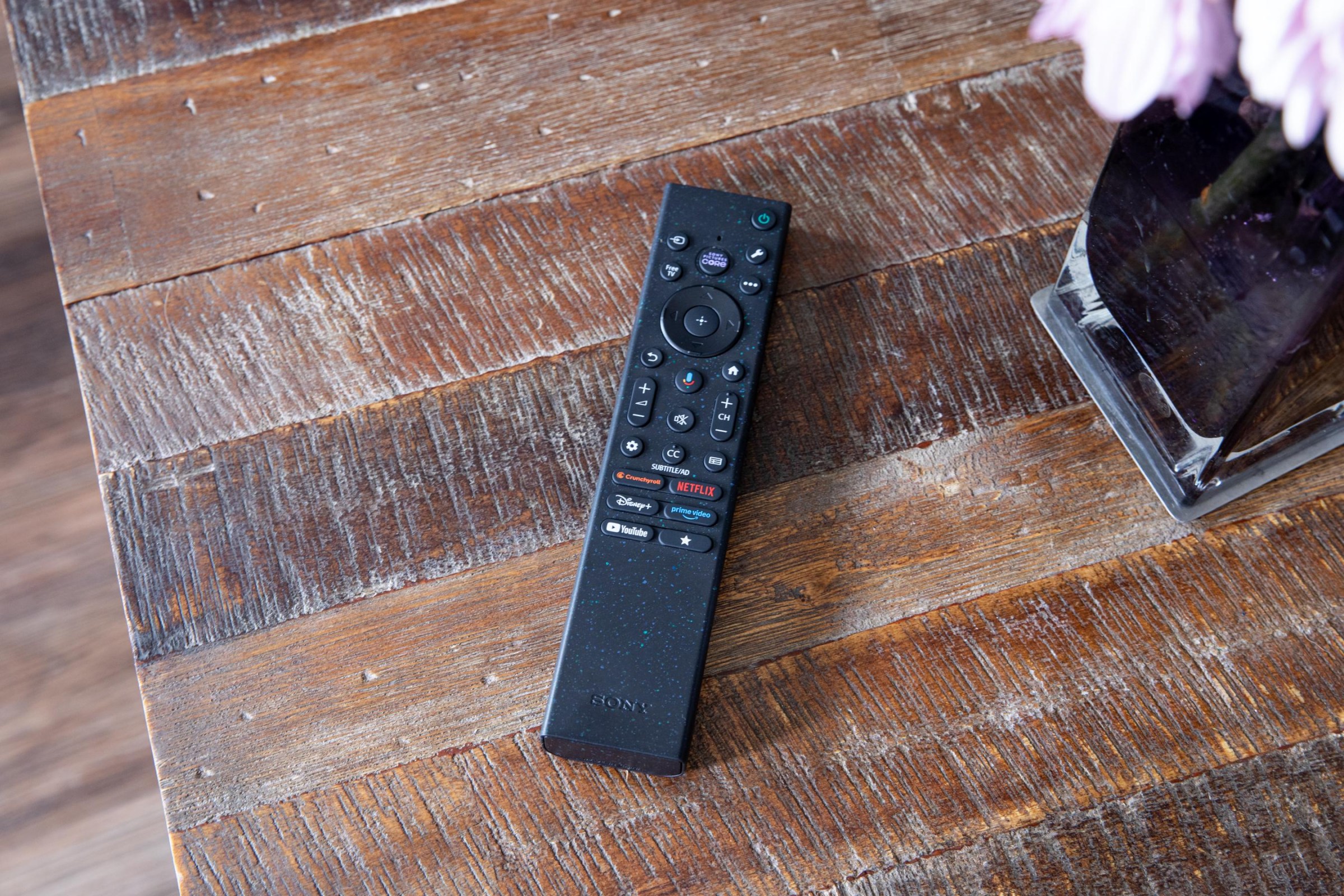 The Sony Bravia 7 II remote on a wooden coffee table.