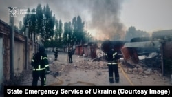 Ukrainian firefighters at the site of a missile strike on Bila Tserkva on May 24