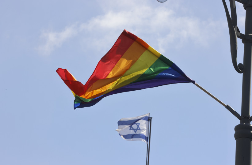 The LGBTQ+ rainbow flag is seen flying along with the flag of Israel during Gay Pride Parade in Jerusalem, May 30, 2024