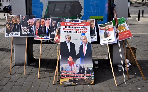 Demonstration placards are seen outside the Vancouver Convention Centre during the 76th FIFA Congress
