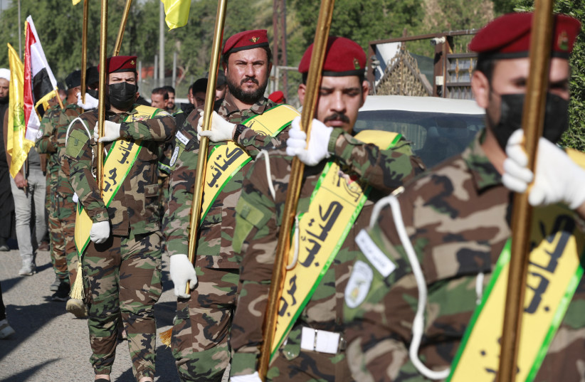 Members of the Iran-backed Iraqi militias al-Nujaba and Kataib Hezbollah appear in Baghdad on December 4, 2023.
