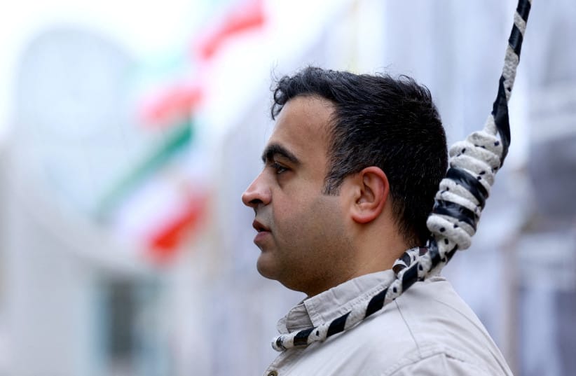A man wears a noose around his neck as supporters of the National Council of Resistance of Iran gather to protest against the death penalty in their home country and for the Islamic Revolutionary Guard Corps to be declared a ''terrorist organization,'' in Berlin, Germany, November 14, 2024.