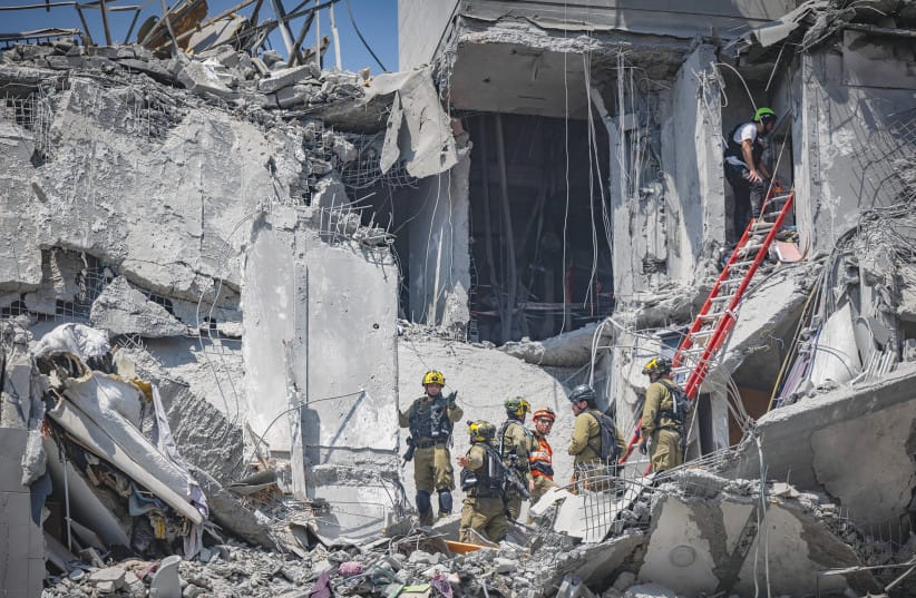 The scene where a ballistic missile fired from Iran hit and caused damage in Beersheba in June: Missiles may have stopped falling, but a far more insidious, silent, and sophisticated assault continues – cyber warfare and phishing, the writer warns.