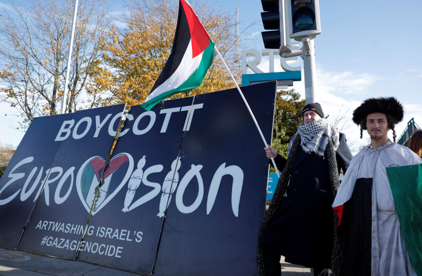 Pro-Palestinian protestors hold a flag and a banner outside the RTE (Radio Telefis Eireann) Irish public service broadcaster television studios as demonstrators call for an Irish boycott of the 2026 Eurovision Song Contest if there is Israeli participation, in Dublin, Ireland, November 1, 2025.
