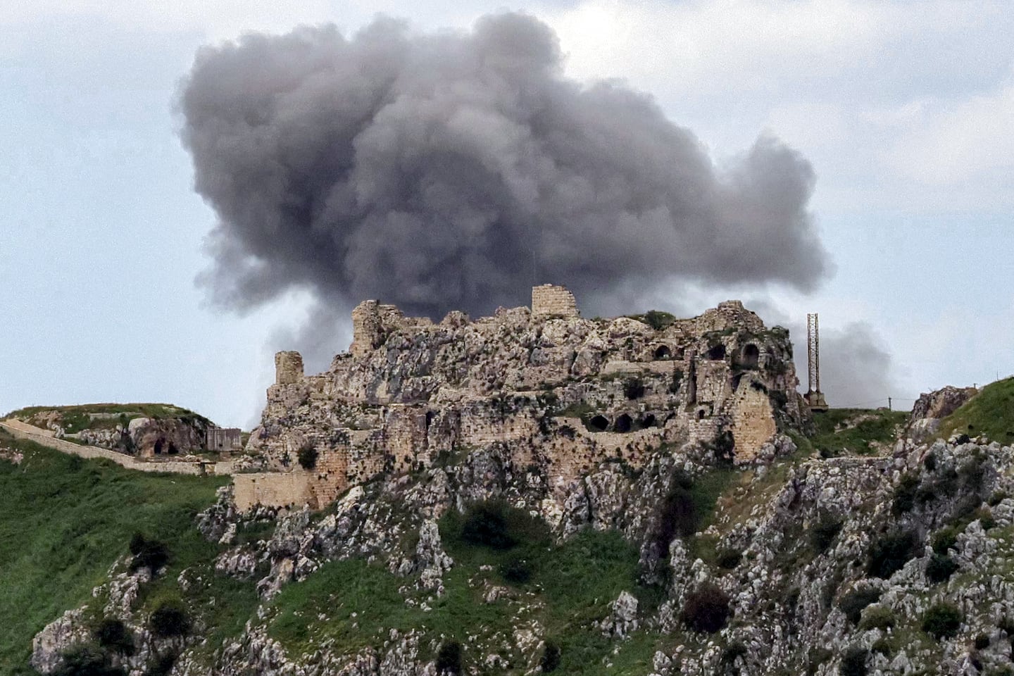 Smoke rises from Israeli bombardment on the village of Yohmor in southern Lebanon behind the 12th century Crusader-era Beaufort (Belfort) Castle, known locally as Qalat al-Shaqif or Shaqif Arnun, as seen from nearby Marjeyoun (Marjayoun) on May 6, 2026.