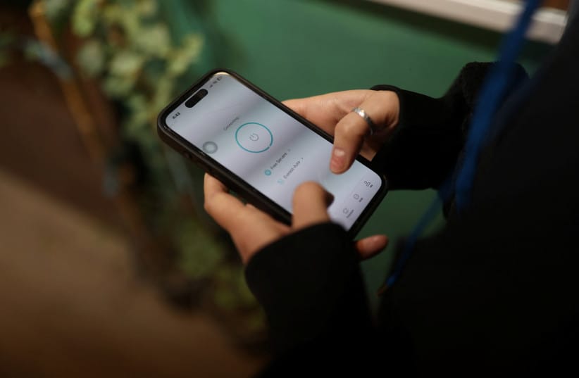 An Iranian woman, Samaneh, shows her mobile phone, after a nationwide internet shutdown since January 8, 2026, following Iran's protests, in Tehran, Iran, January 25, 2026 (credit: MAJID ASGARIPOUR/WANA