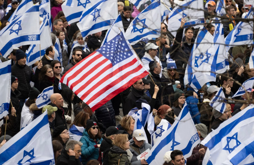 Demonstrators hold US and Israeli flags during a rally in Central Park marking 150 days since hostages were taken in attack on Israel on March 10, 2024 in New York City.