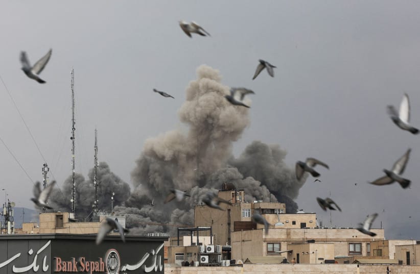 Birds fly as smoke rises following an explosion, after Israel and the US launched strikes on Iran, amid the US-Israel conflict with Iran, in Tehran, Iran, March 2, 2026. (credit: MAJID ASGARIPOUR/WANA