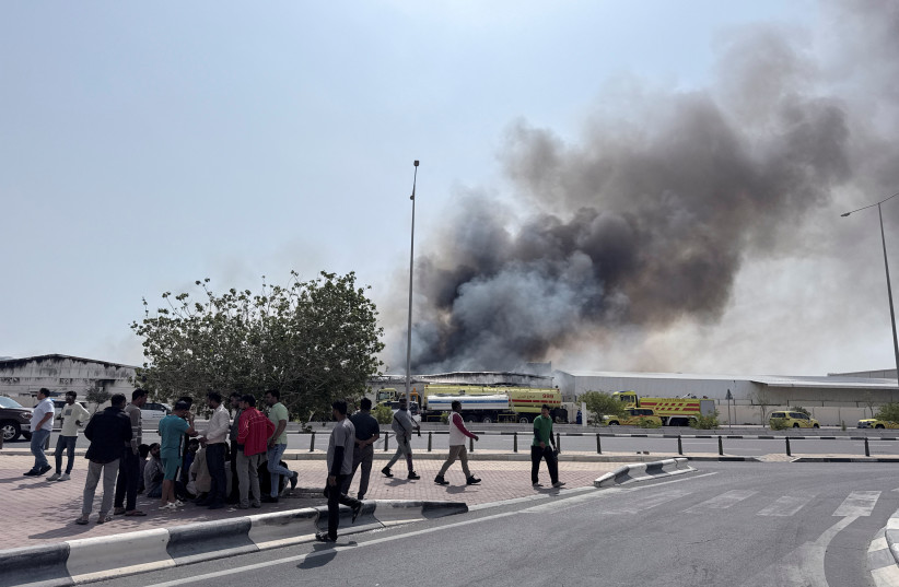 People gather as smoke rises at the Industrial Area after reported Iranian missile attacks, following United States and Israel strikes on Iran, in Doha, Qatar, March 1, 2026