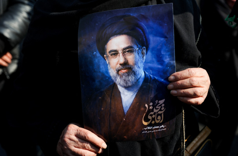 A woman holds a portrait of Iran's new supreme leader Mojtaba Khamenei, on the day of a gathering to support Mojtaba Khamenei, amid the US-Israeli conflict with Iran, in Tehran, Iran, March 9, 2026.