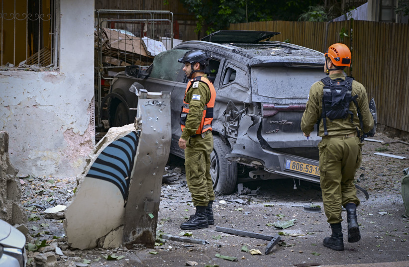 Israeli security and rescue forces at the scene where a missile fired from Iran toward Israel caused damage in Tel Aviv, April 1, 2026.