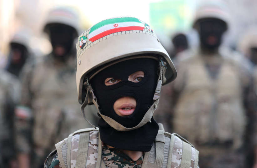 A member of Iranian militia forces (Basij) attends an anti-Israeli march in Tehran, Iran, January 10, 2025. (credit: Majid Asgaripour/WANA