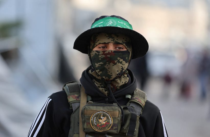 A HAMAS terrorist stands on a street during Eid al-Fitr in Gaza City.