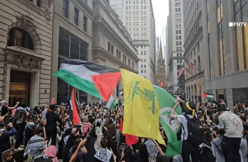 Hezbollah, Palestinian flags waved during a march in New York, June 11, 2024. (Illustrative)