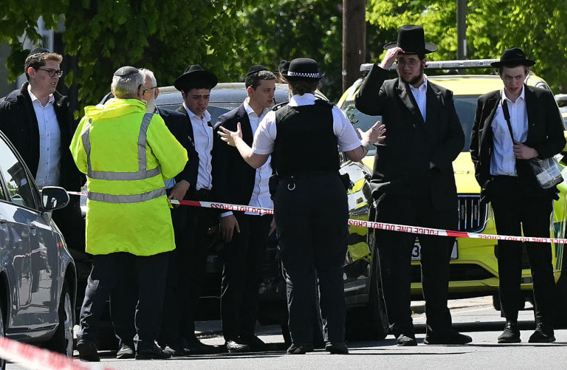 LOCAL RESIDENTS look on from outside a cordoned off area in the Golders Green neighbourhood of north London on April 29, 2026, following the stabbing to two people nearby.