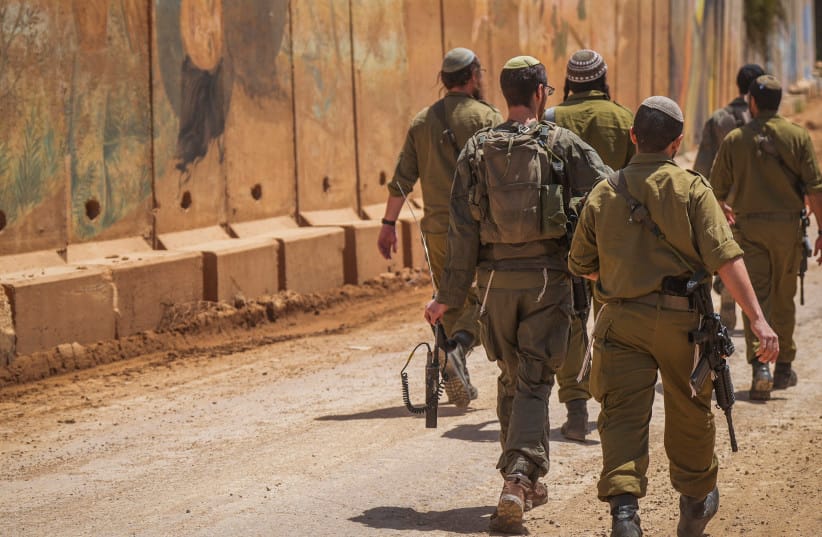 Israeli soldiers are seen near the concrete wall in Moshav Shtula, along the Israeli border with Lebanon in northern Israel, during a ceasefire, April 27, 2026.