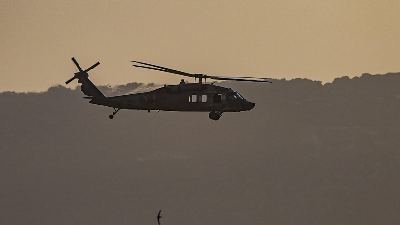 An Israeli military helicopter flies near the Israeli border with Lebanon, May 12, 2026. 